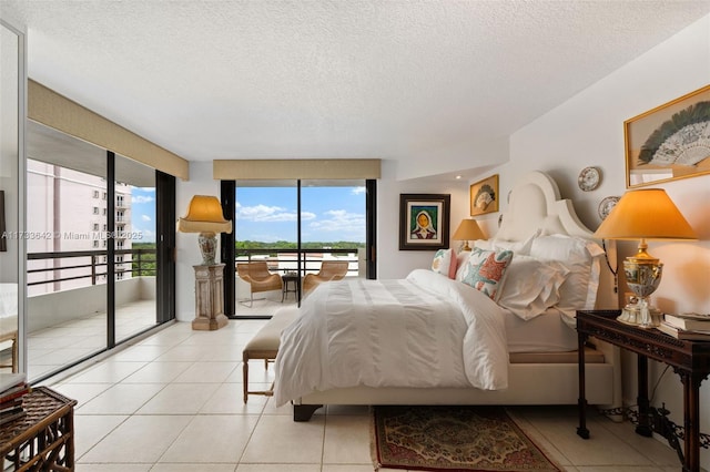 tiled bedroom featuring access to exterior and a textured ceiling