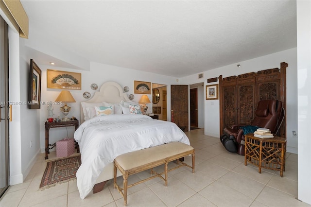 bedroom with a textured ceiling and light tile patterned flooring