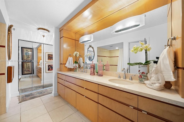 bathroom featuring tile patterned flooring and vanity