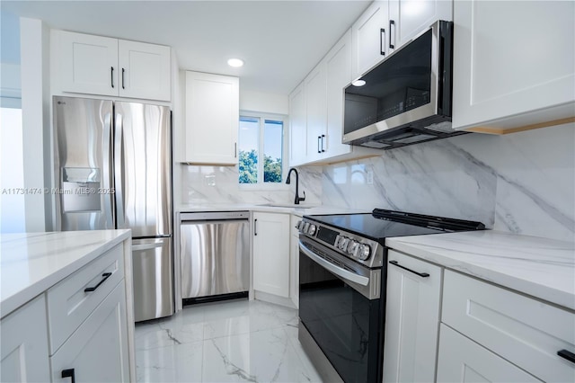 kitchen featuring stainless steel appliances, sink, and white cabinets