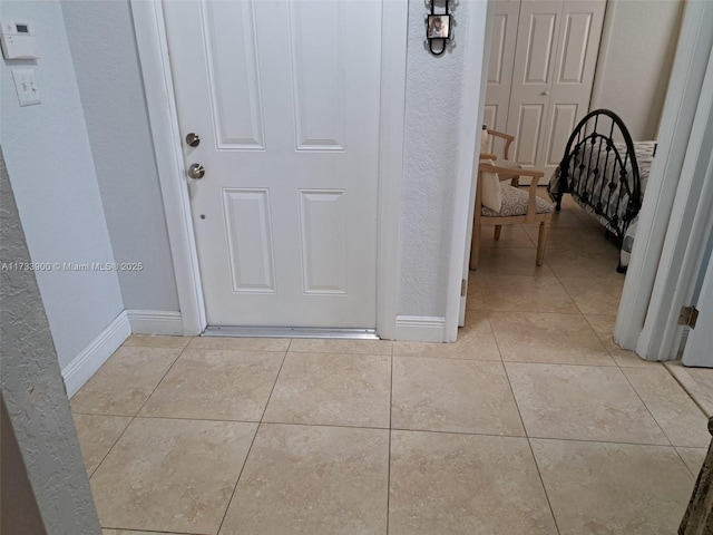 hallway featuring light tile patterned flooring