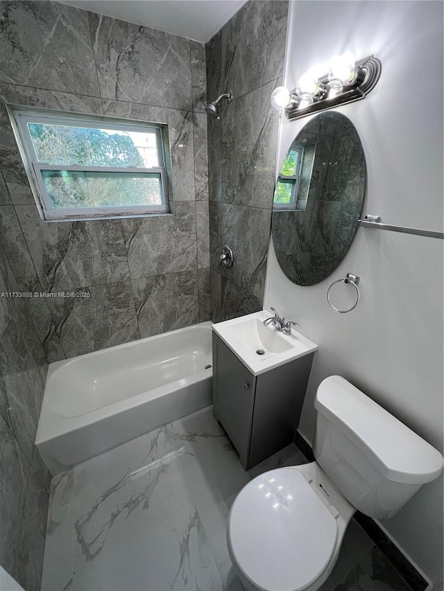 full bathroom with tiled shower / bath, vanity, and toilet