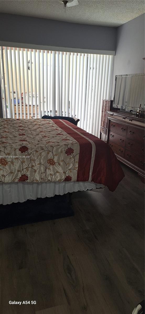 bedroom featuring wood-type flooring and a textured ceiling