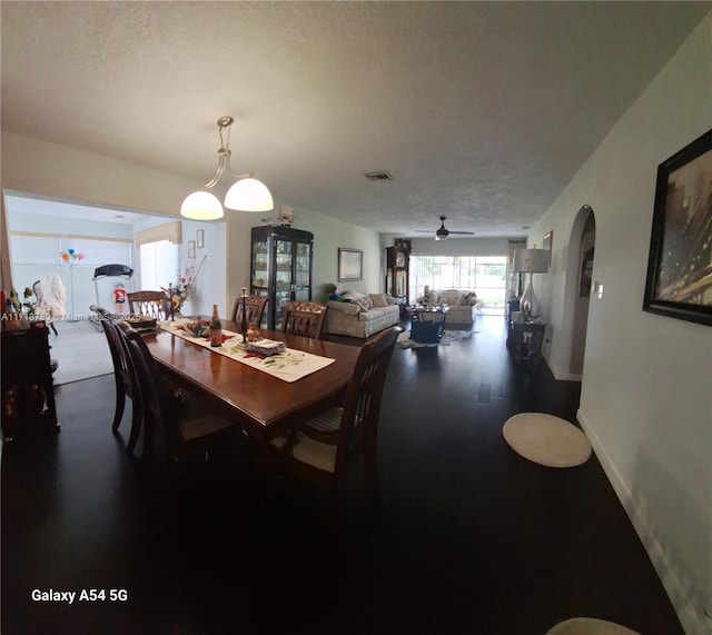 dining room featuring ceiling fan and a textured ceiling