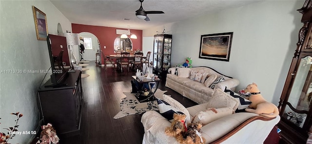 living room with ceiling fan and dark hardwood / wood-style floors