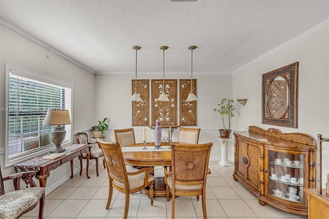 dining room with light tile patterned floors, ornamental molding, and a textured ceiling