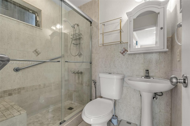 full bathroom with toilet, a shower stall, and tile walls