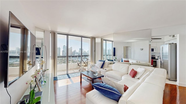 living room with expansive windows and hardwood / wood-style floors