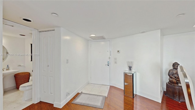 bathroom featuring hardwood / wood-style flooring and toilet