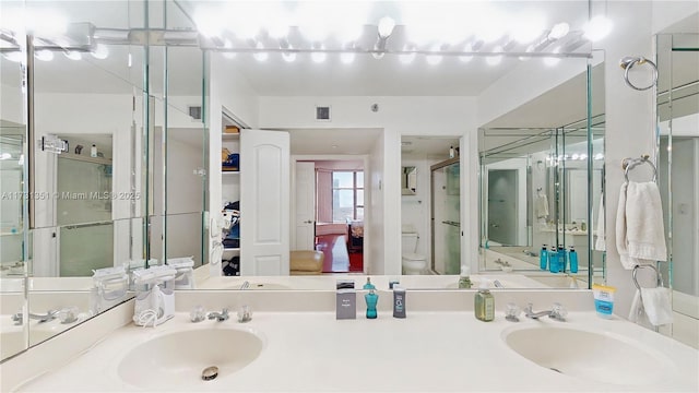 bathroom with vanity, toilet, and walk in shower