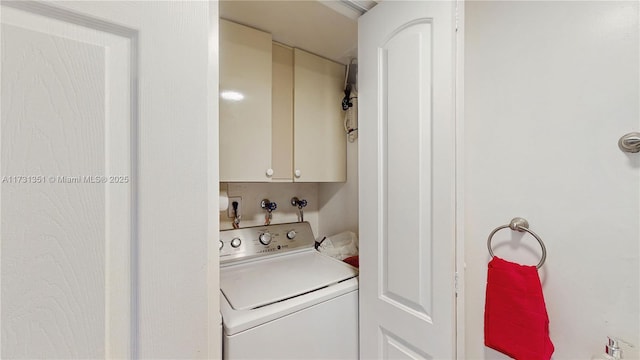 laundry area with cabinets and washer / clothes dryer