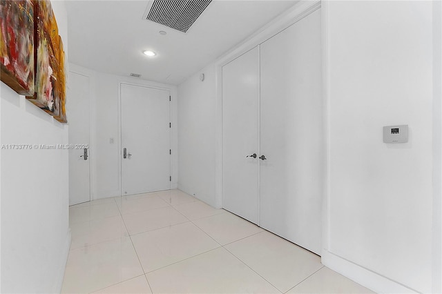 hallway featuring light tile patterned floors