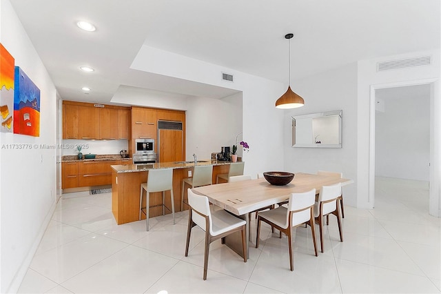 tiled dining room with sink