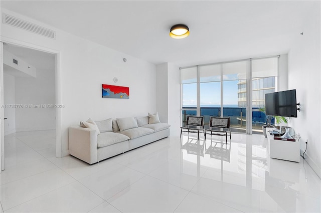 tiled living room with a wall of windows