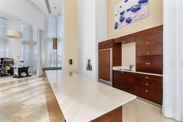 interior space with a high ceiling and light tile patterned flooring