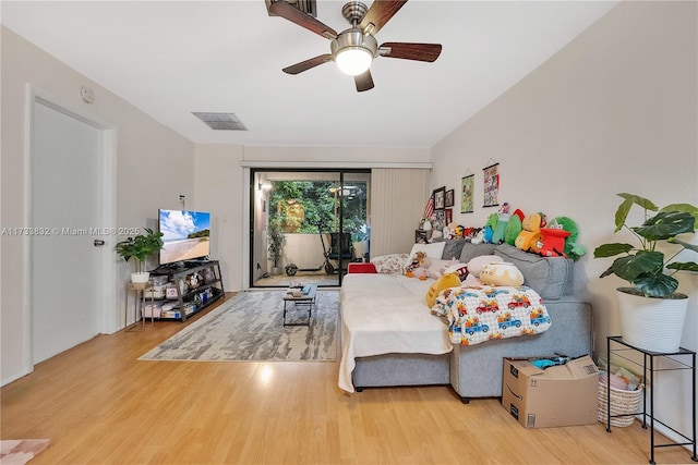 bedroom featuring hardwood / wood-style flooring, access to outside, and ceiling fan