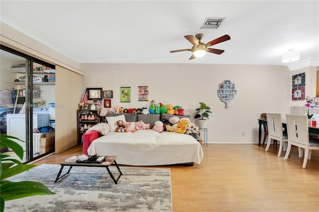 bedroom with ceiling fan and light wood-type flooring