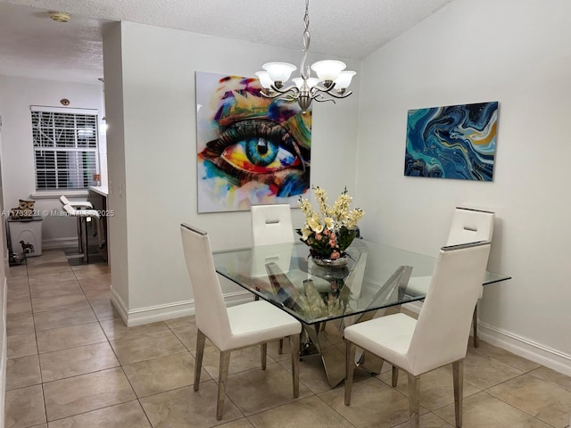 dining area with a notable chandelier, light tile patterned floors, and a textured ceiling