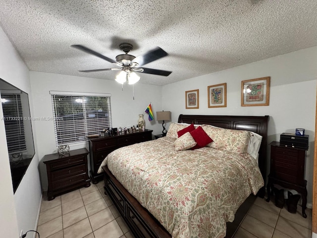 tiled bedroom featuring a textured ceiling and ceiling fan