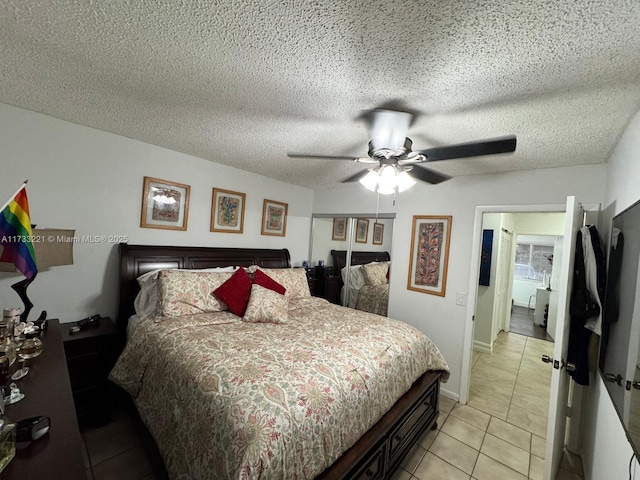 bedroom featuring light tile patterned floors, a textured ceiling, and ceiling fan