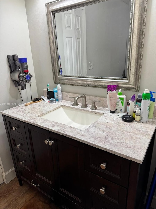 bathroom with vanity and hardwood / wood-style flooring