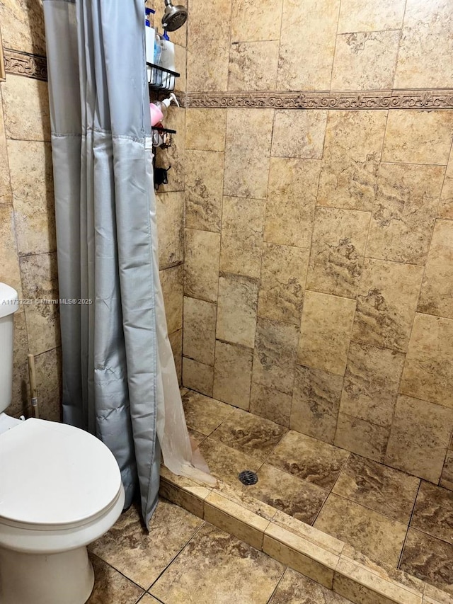 bathroom with walk in shower and toilet