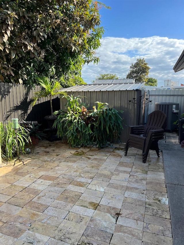 view of patio / terrace featuring a storage unit