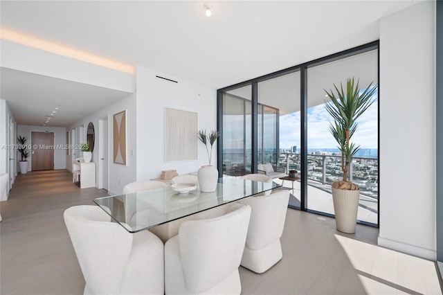 dining space with expansive windows and wood finished floors