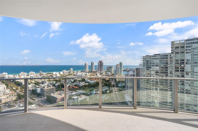 balcony featuring a view of city and a water view