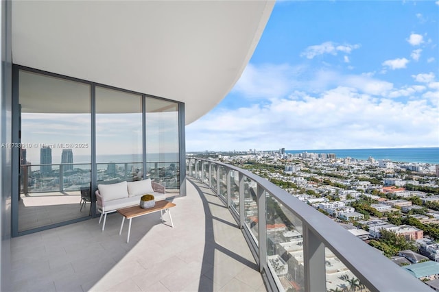 balcony with a water view and a view of city