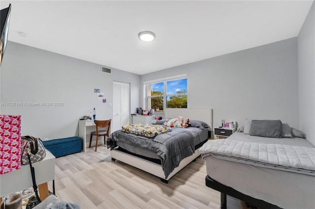 bedroom featuring light hardwood / wood-style floors and a closet