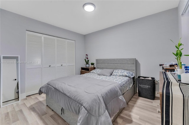 bedroom featuring light wood-type flooring and a closet