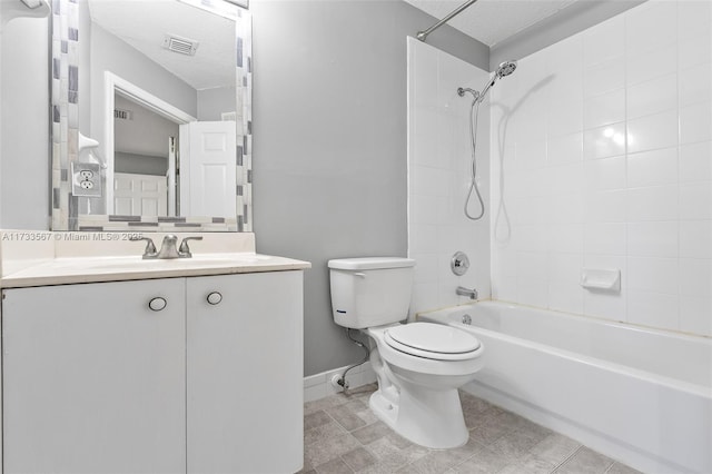 full bathroom featuring vanity, toilet, tiled shower / bath combo, and a textured ceiling