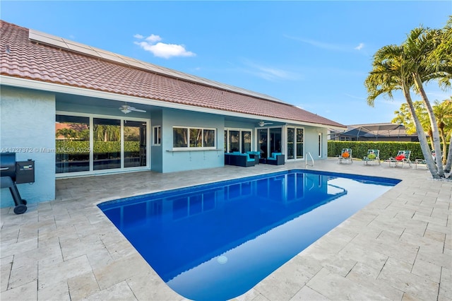 view of pool with a patio, outdoor lounge area, and ceiling fan