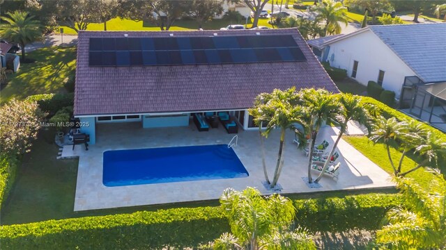 view of pool with an outdoor hangout area, a patio area, and ceiling fan