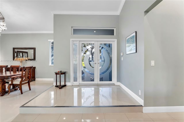 foyer entrance featuring tile patterned flooring, crown molding, and french doors