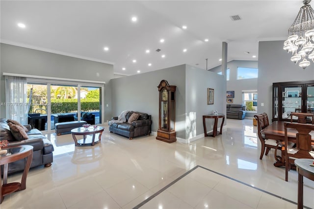 tiled living room with a high ceiling, crown molding, a healthy amount of sunlight, and a notable chandelier