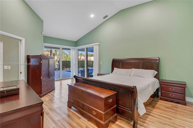 bedroom with access to exterior, light hardwood / wood-style flooring, and high vaulted ceiling