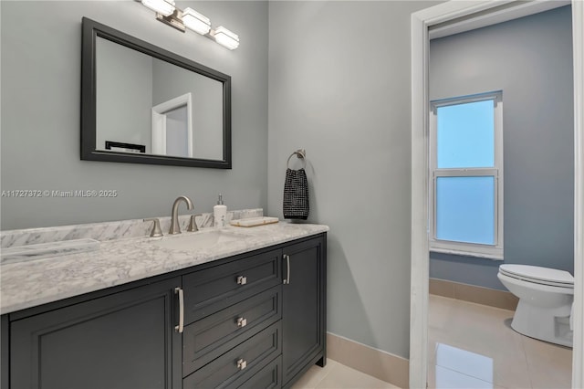 bathroom with vanity, tile patterned floors, and toilet