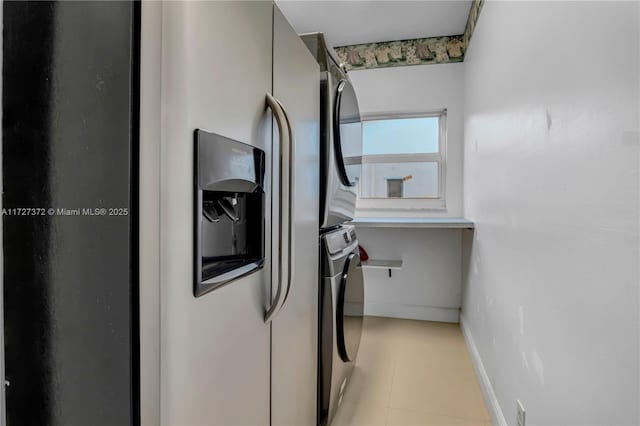 laundry area featuring stacked washer and dryer