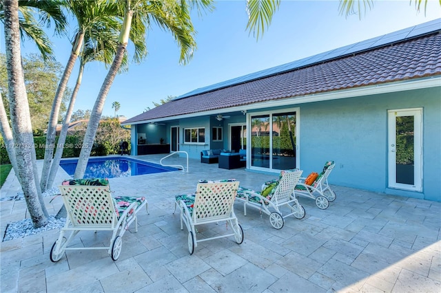 view of pool with ceiling fan, outdoor lounge area, and a patio area