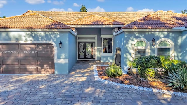 mediterranean / spanish home featuring a garage