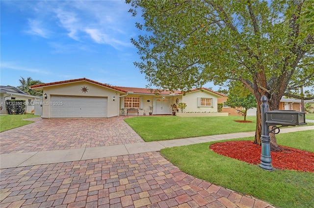 view of front of home featuring a garage and a front yard