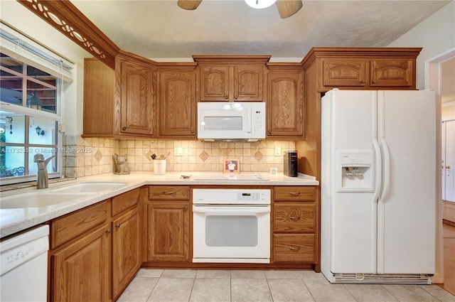 kitchen with ceiling fan, white appliances, sink, and decorative backsplash