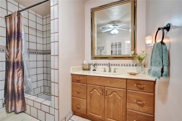 bathroom with vanity, curtained shower, and ceiling fan