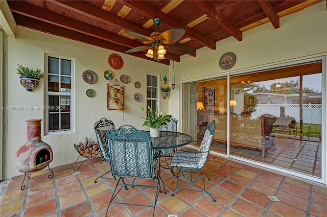 view of patio with ceiling fan and a fireplace