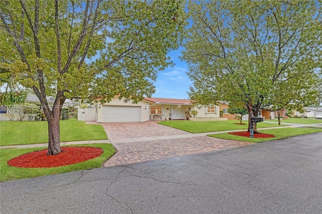 view of front of house with a garage and a front lawn