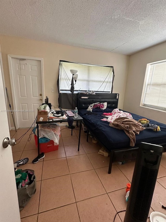 bedroom featuring tile patterned flooring and a textured ceiling