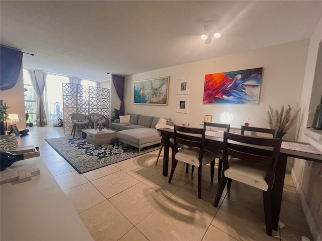 dining area with tile patterned flooring and expansive windows