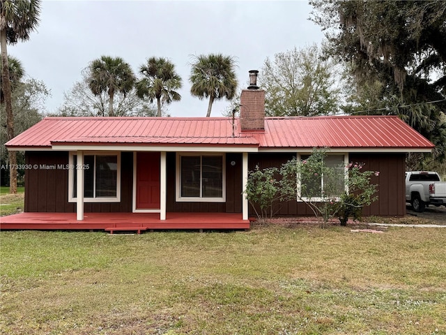 back of house with a lawn